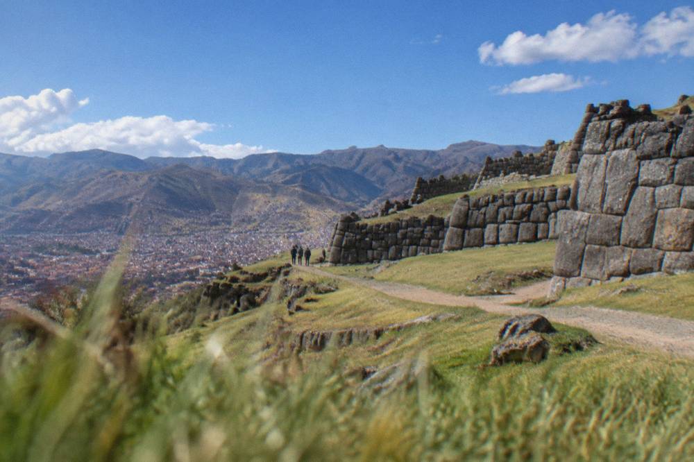 The terraced stone walls of Saqsayhuaman above the city of Cusco under morning light