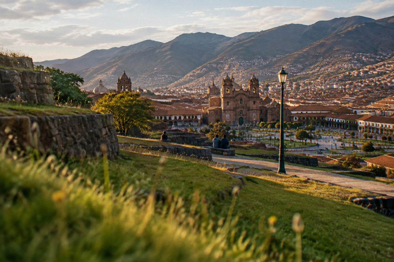 Stone terraces above Cusco with the red-tiled roofs of the city spread across the valley below