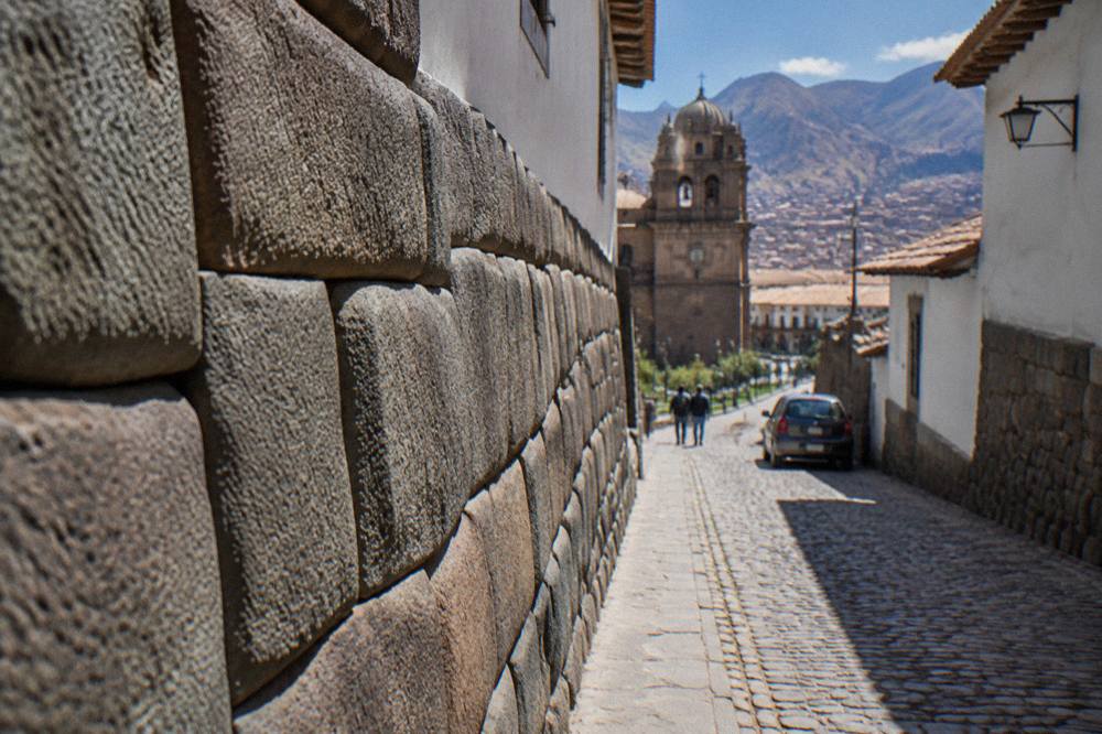 A quiet stone lane in the Cusco historic centre with Inca wall foundations