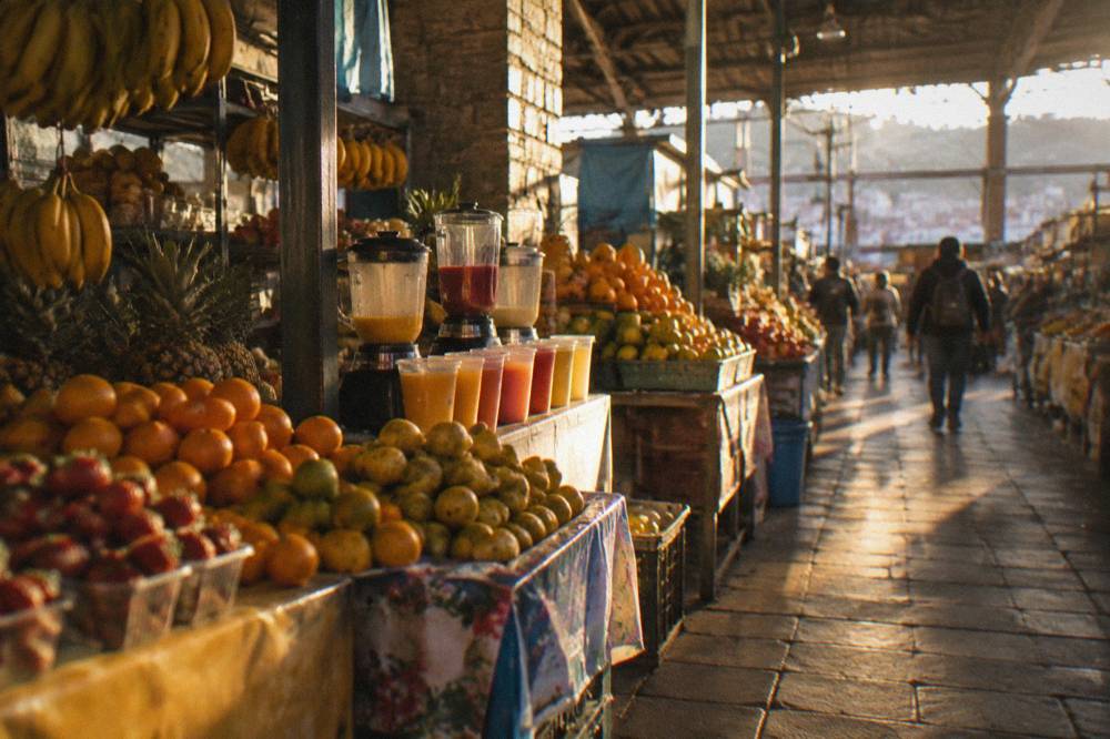 Stalls with fruit and juices inside San Pedro Market in Cusco