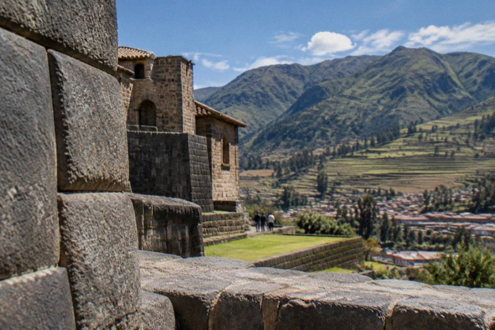 Terraced Andean farmland in the Sacred Valley below green hills
